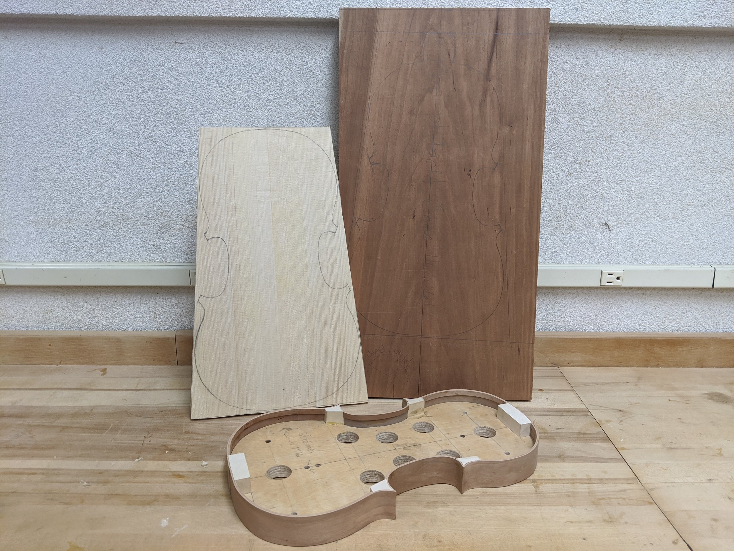 Wood for building the violin with partially finished garland.
